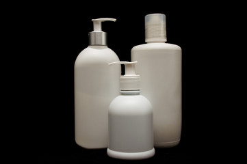 white plastic cosmetic bottle on black background