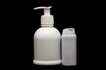white plastic cosmetic bottle on black background