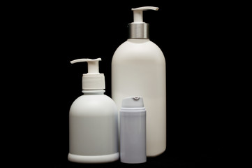white plastic cosmetic bottle on black background