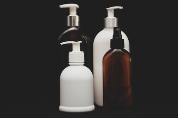 white plastic cosmetic bottle on black background