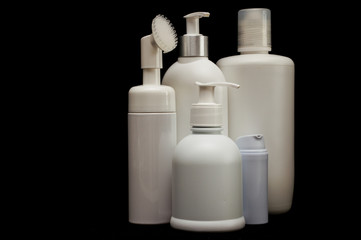 white plastic cosmetic bottle on black background
