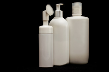white plastic cosmetic bottle on black background