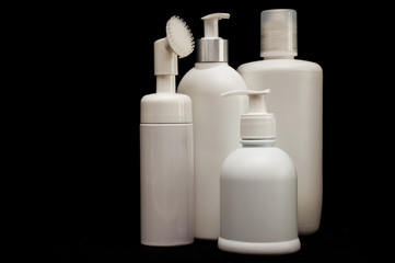 white plastic cosmetic bottle on black background