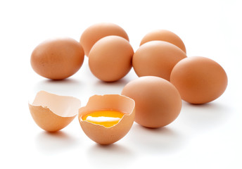 Eggs and broken eggs placed on a white background