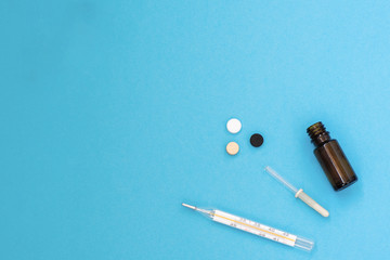Medical products for the treatment of diseases on a blue background. Top view. Copy space. Flat lay