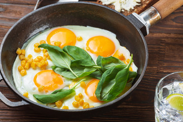 Fried eggs for breakfast close-up. Wooden table. Healthy eating