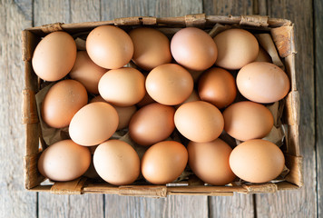 Raw natural chicken eggs in a box. View above.
