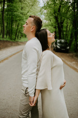 Beautiful pregnant couple in woods