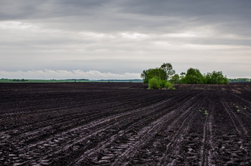 Plowed field in spring. The tractor finished plowing the field