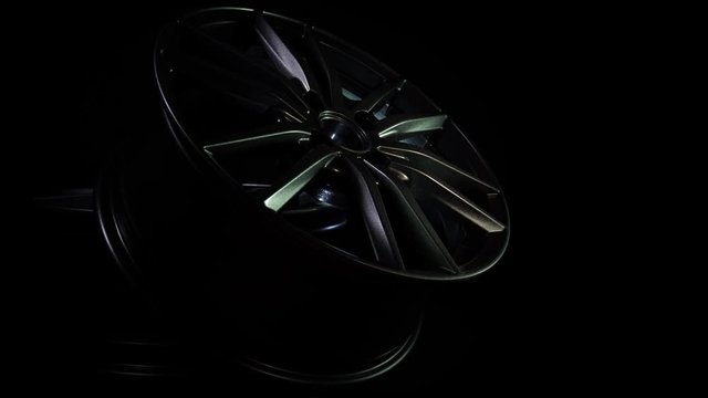 New alloy wheels for auto and vehicle in dark background. Modern steel equipment for car. Expensive bright metal disks made of carbon. Luxury design. Clean aluminium magnesium wheels stand. Cast drive