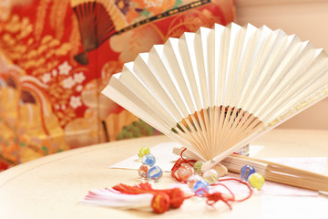 Traditional Japanese fans, marbles and origami decorations on the table