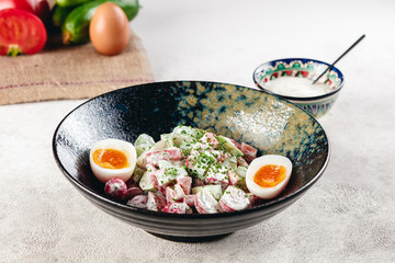 Vegetable salad with boiled eggs mixed with sour cream 