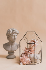 An ornamental composition of artificial flowers. Home decoration. Decor for the studio. Classic decor. Artificial flowers. Decorative flowers with own hands. David's head. 