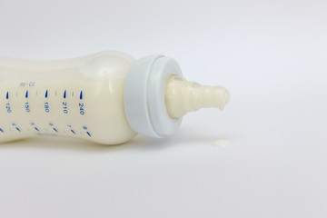 milk in baby bottle on white background