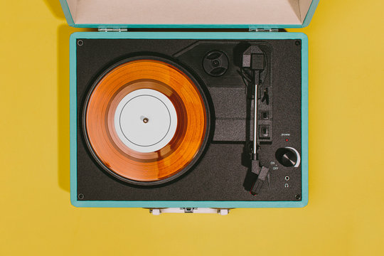 Vintage turntable with yellow background