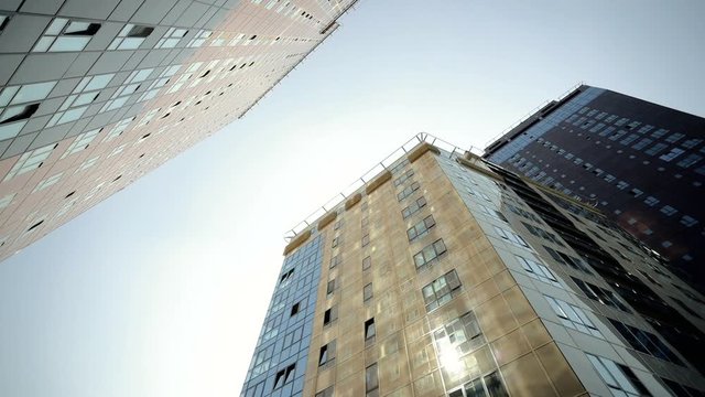 Exterior of two high rise buildings in Moscow. View of two skyscrapers against blue sky. HD