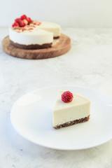 Slice of raw almond cake with raspberries on a plate. Healthy food concept. Lactose free, gluten free, sugar free.