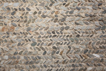 ancient wall made with river peebles with copy space for your text