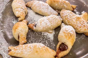 Homemade baking with powdered sugar as traditional holiday cookie closeup.