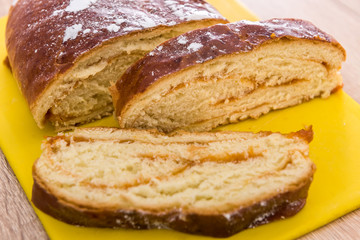 Sweet pastry, pie bun with red sweet strawberry jam inside slices of dessert with powder