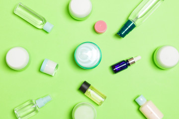 Group of plastic bodycare bottle Flat lay composition with cosmetic products on green background empty space for you design. Set of White Cosmetic containers, top view with copy space