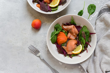keto lunch salmon salad spinach, arugula, sesame and lemon. dish for a healthy lunch or dinner. menu healthy food delivery. Top view with copy space.