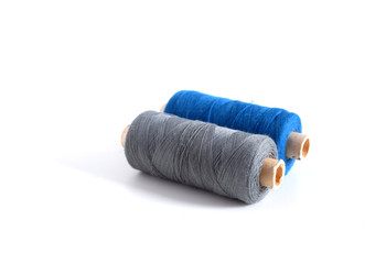 Fototapeta na wymiar Blue and gray threads on a white background. Suitable for advertising background. Sewing supplies