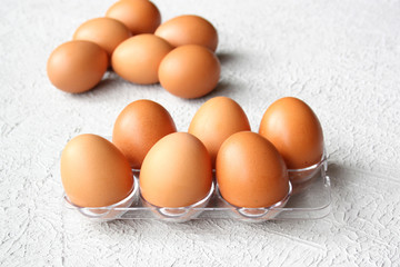 Raw egg in the package on a gray background. Omelet, fried egg.
