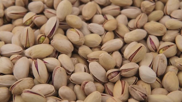 Heap of fresh and roasted pistachios 