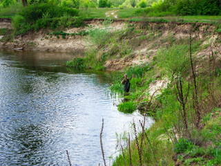 fisherman in the grass on the river