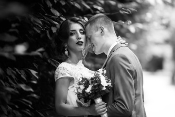 Elegant bride and groom posing together outdoors on a wedding day