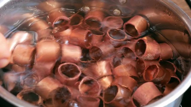 copper rings are boiled in water with soda for use in brewing