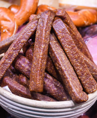 Many homemade German mix of meat specialties, speck ham sausages pile or stack on counter top