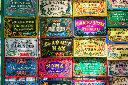 BUENOS AIRES, ARGENTINA - FEBRUARY 24, 2016: Funny spanish door welcoming boards on La Boca market in Buenos Aires district.