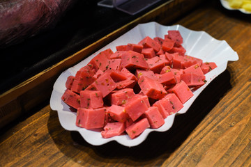Vienna, Austria, 27th of November 2019: Multi colored cheese wheels on counter top for sale