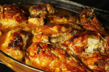 Delicious sliced baked chicken in the oven close up