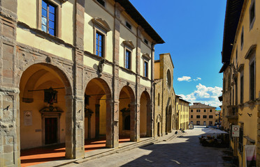 Fototapeta na wymiar Detail of main square with cathedral entrance in old historic alley in the medieval village of Sansepolcro near city of Arezzo in Tuscany, 