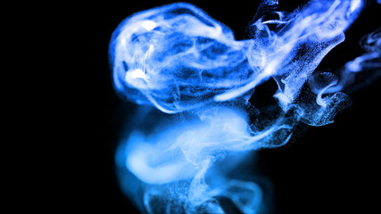 injection of blue fluorescent ink in water isolated on black background. 3d render of glow particles as fantastic background of shiny ink effect advection with depth of field.