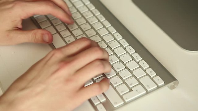 hands typing on keyboard. Man working at the computer. Office worker