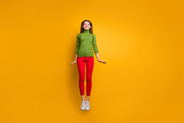 Fototapeta na wymiar Full body photo of positive cheerful girl have free time jump feel candid emotions wear casual style clothing isolated over yellow color background