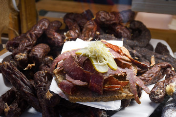 Speck is a typical cold cuts of North Italy for sale at delicatessen shop. Mix of meat cuts,sausages