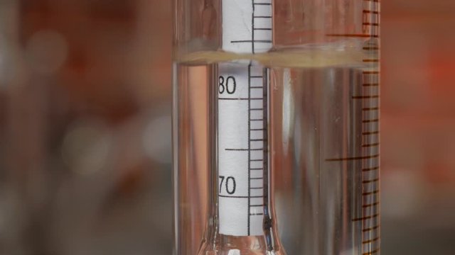 alcohol fills the flask in which the hydrometer is located and measures the alcohol strength