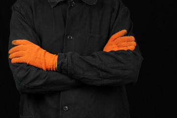 a worker in a special uniform and gloves on a black background