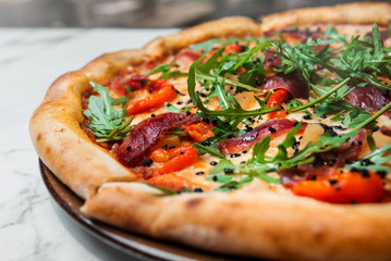 Italian food. Pizza with arugula and prosciutto. Side view