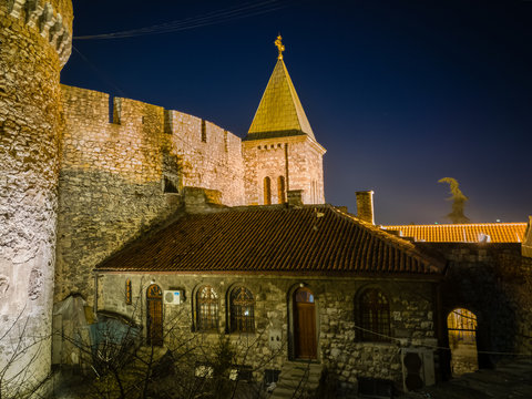 Ruzica church or Crkva Ruzica in Kalemegdan fortress or Belgrade fortress under wall of zindan tower at night, illuminated by night lights.