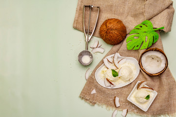 Lactose free coconut ice cream. Special spoon, halves of fruit, flakes