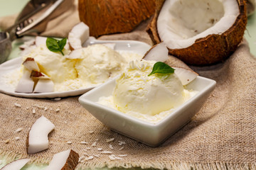 Lactose free coconut ice cream. Special spoon, halves of fruit, flakes