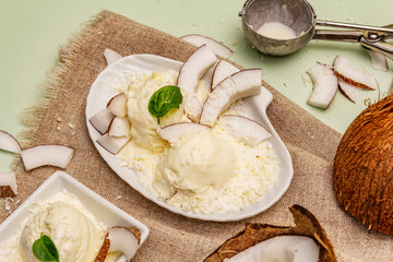 Lactose free coconut ice cream. Special spoon, halves of fruit, flakes