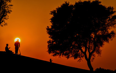 People or Family Silhouette Enjoying in the Park at Sunset, Silhouettes Against the Backdrop of a Bright