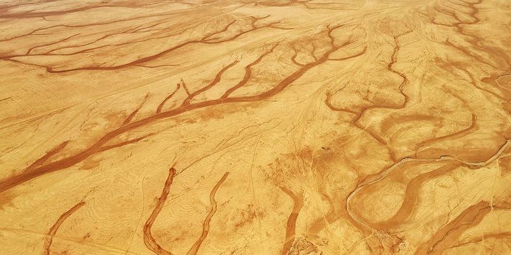 Abstract pattern of desert sand ripples in hot summer day. Aerial view on the arabic sand dunes near Amman, Jordan